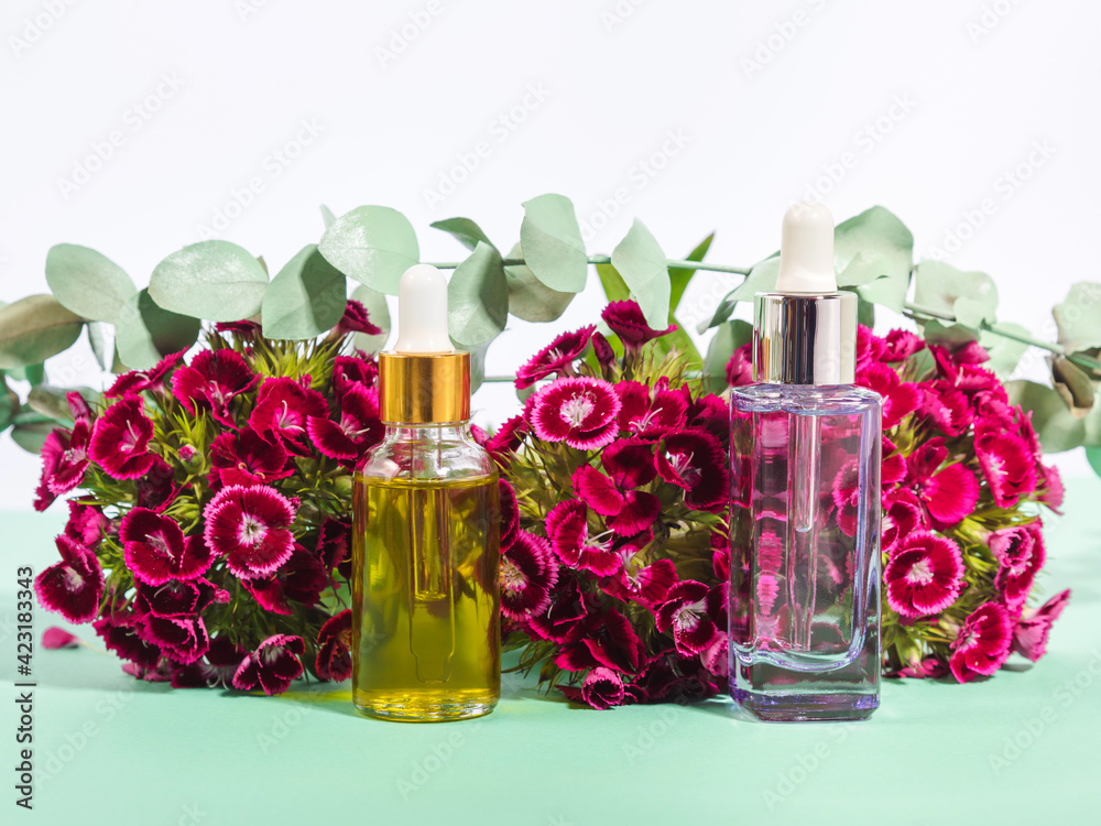 Essential oil Vitamin C natural beauty product and hyaluronic acid serum in glass bottles Essential oil Vitamin C natural beauty product and hyaluronic acid serum in glass bottles