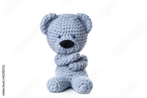Bear handmade toy isolated on white background. Crochet blue bear