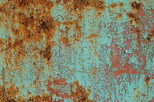 Metal sheet rusty faded texture. Peeling turquoise paint on a concrete wall. Steel plate background. © Tetiana