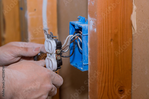 Replacing old broken an electrical outlet into the wall box