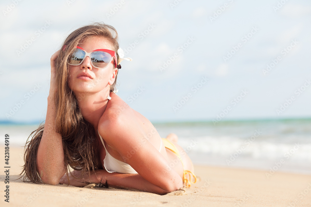 Smiling beautiful woman sunbathing on a beach Smiling beautiful woman sunbathing on a beach