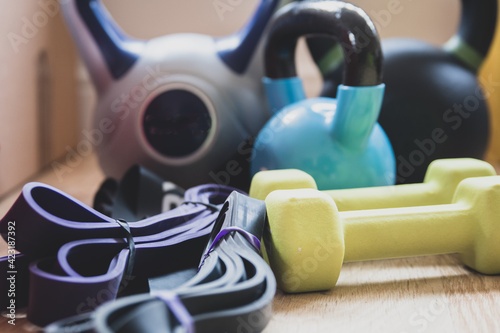 Weights, kettlebells and stretch bands on the floor for exercising at home whilst gyms remain shut.