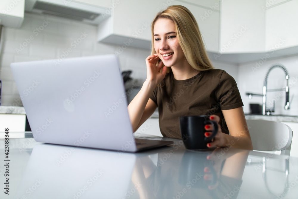 Young woman using laptop while sitting at home Young woman using laptop while sitting at home