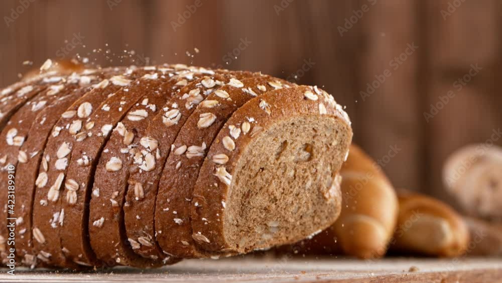Super slow motion of falling sliced freshly baked bread.