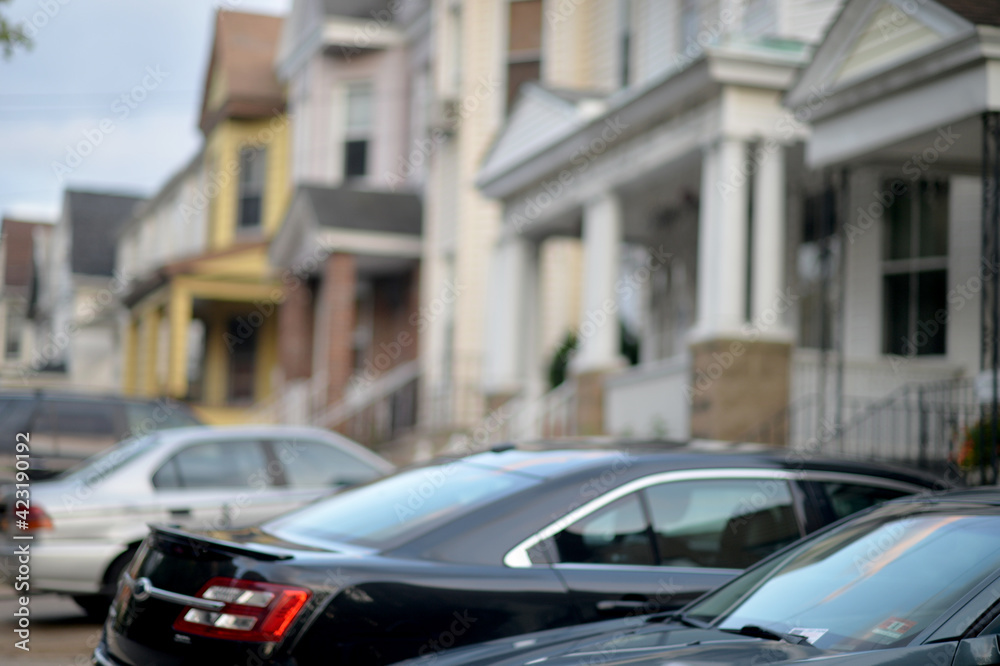 row of cars parked near residential buildings