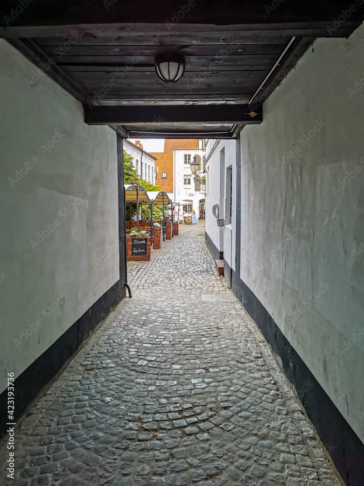 tunnel into public patio of flensburg, old town, germany