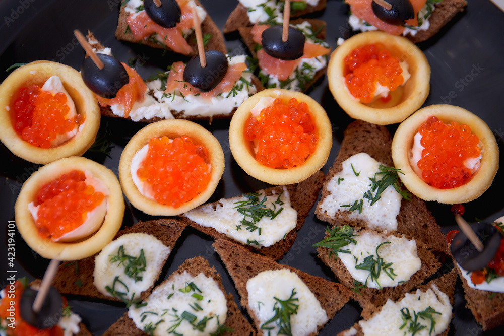 Canape with red caviar and other snacks. View from above Canape with red caviar and other snacks. View from above
