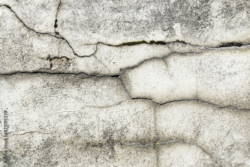 Gray cement black cracks background. Scratched lines texture. White and black distressed grunge concrete wall pattern for graphic design. Peel paint crack. Weathered rustic surface.