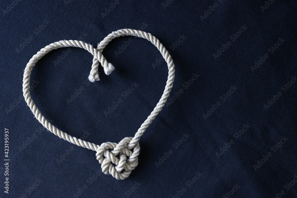 A heart shaped knot made of white rope. Love concept. A heart shaped knot made of white rope. Love concept.