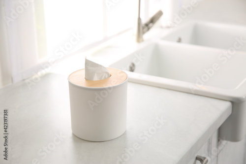 Box with paper tissues on white countertop in kitchen