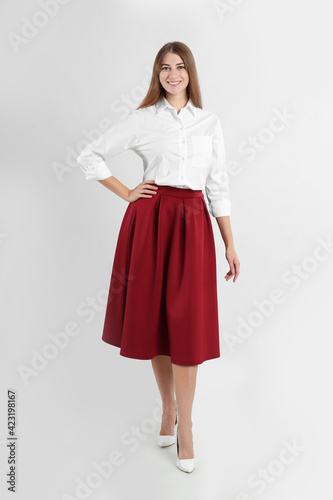 Full length portrait of beautiful young businesswoman on white background
