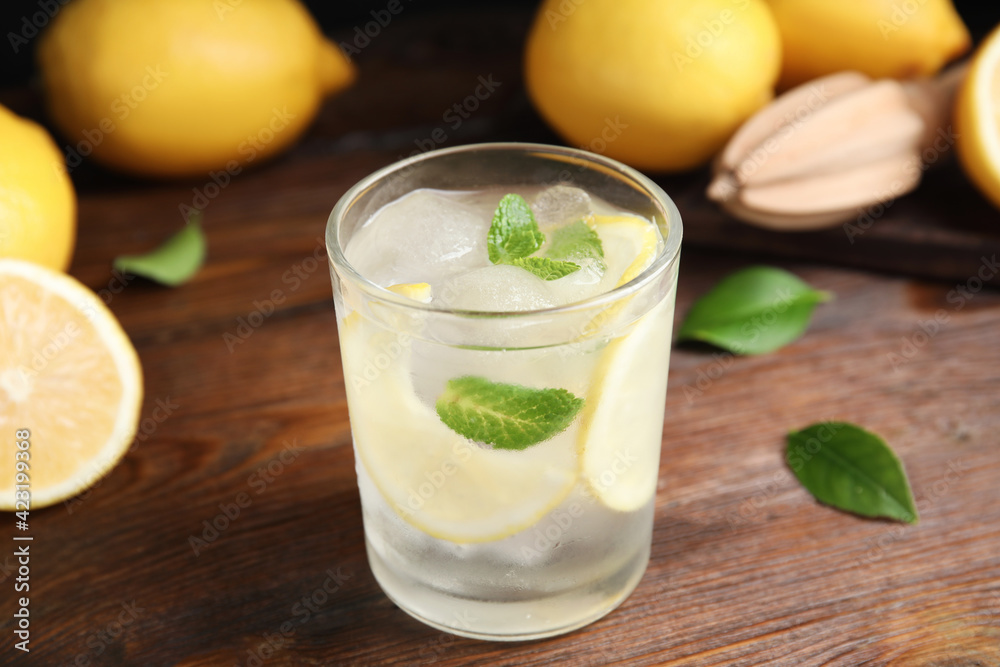 Fototapeta premium Cool freshly made lemonade in glass on wooden table, closeup