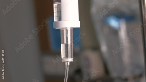 saline solution dripping at hospital room , close up 