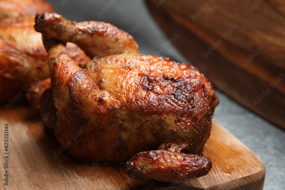 Delicious grilled whole chickens on grey table, closeup
