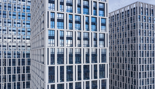 Bottom view of office building window close up, reflection and perspective. Modern architecture with sun ray. Glass facade on a bright sunny day with sunbeams on the blue sky. 