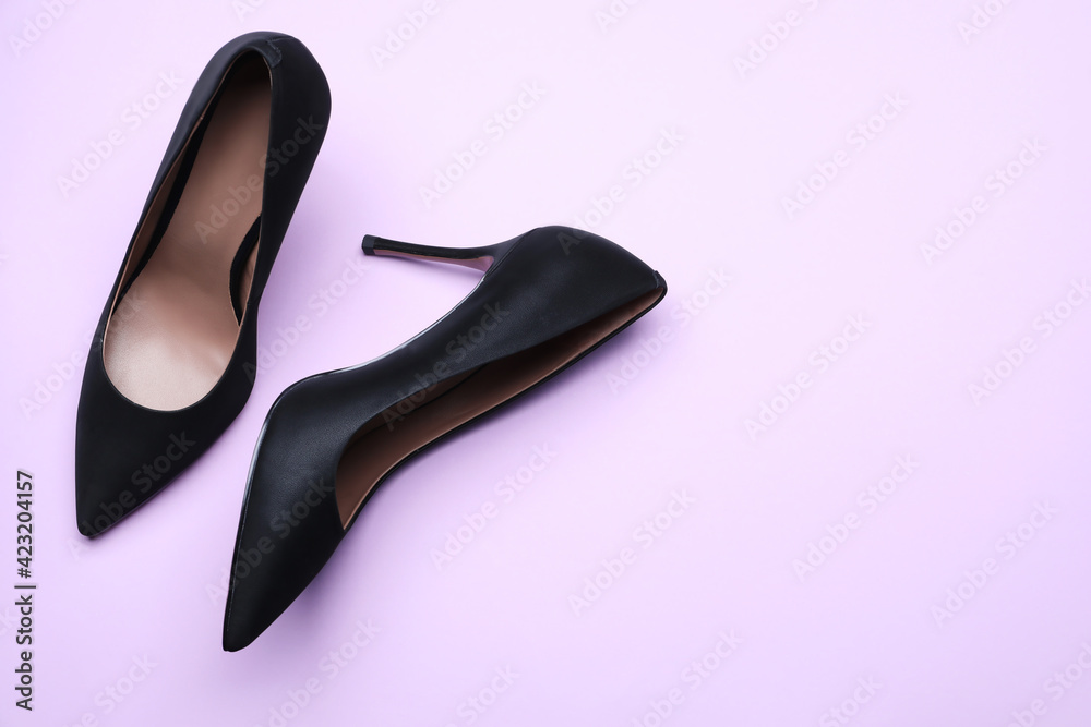 Pair of elegant black high heel shoes on light background, flat lay. Space for text Pair of elegant black high heel shoes on light background, flat lay. Space for text