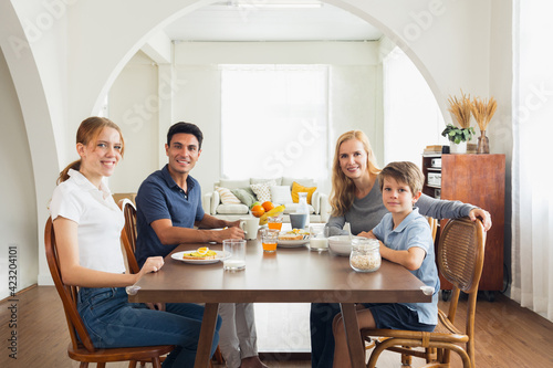 The Caucasian family had breakfast together at home.