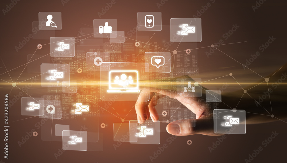 Hand pressing social media multimedia application screen with media icons on futuristic concept Hand pressing social media multimedia application screen with media icons on futuristic concept