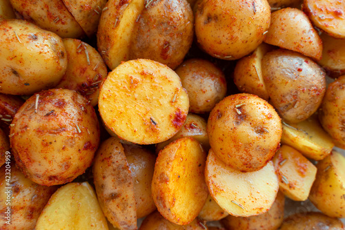 New potatoes cut in half and marinated with rosemary and paprika. Beautiful food background