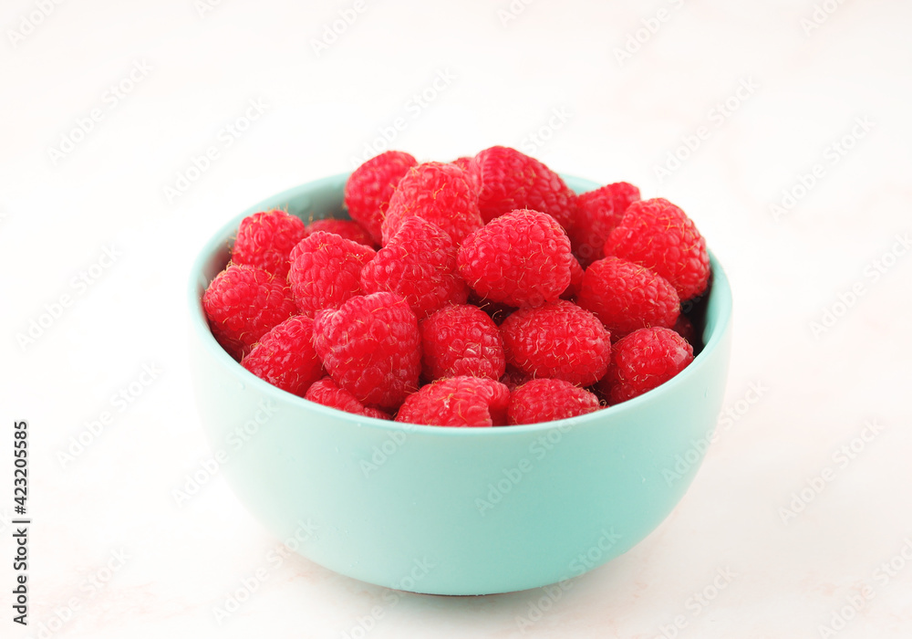 A bowl with ripe bright raspberries A bowl with ripe bright raspberries
