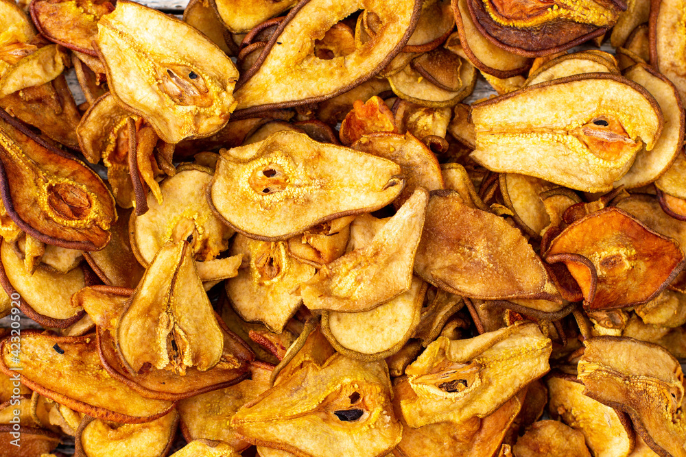 A pile of dried pears in slices. Dried fruit chips. Healthy food