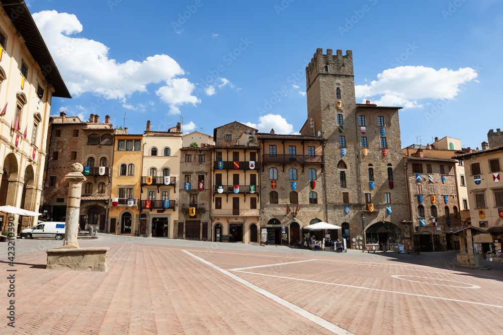 Buildings decorated with coats of arms on Piazza Grande square in Arezzo, Tuscany, Italy