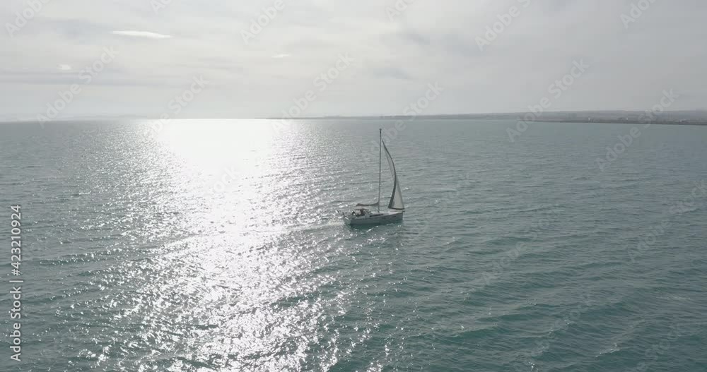Sun yachts with white sails in open sea aerial. Sailing seascape at summer sunny day. Yachting on sailboats at ocean bay. Luxury lifestyle with calm and relax concept. Cinematic serene scenery. Sun yachts with white sails in open sea aerial. Sailing seascape at summer sunny day. Yachting on sailboats at ocean bay. Luxury lifestyle with calm and relax concept. Cinematic serene scenery.