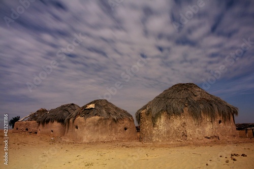 clouds and huts in desert photo