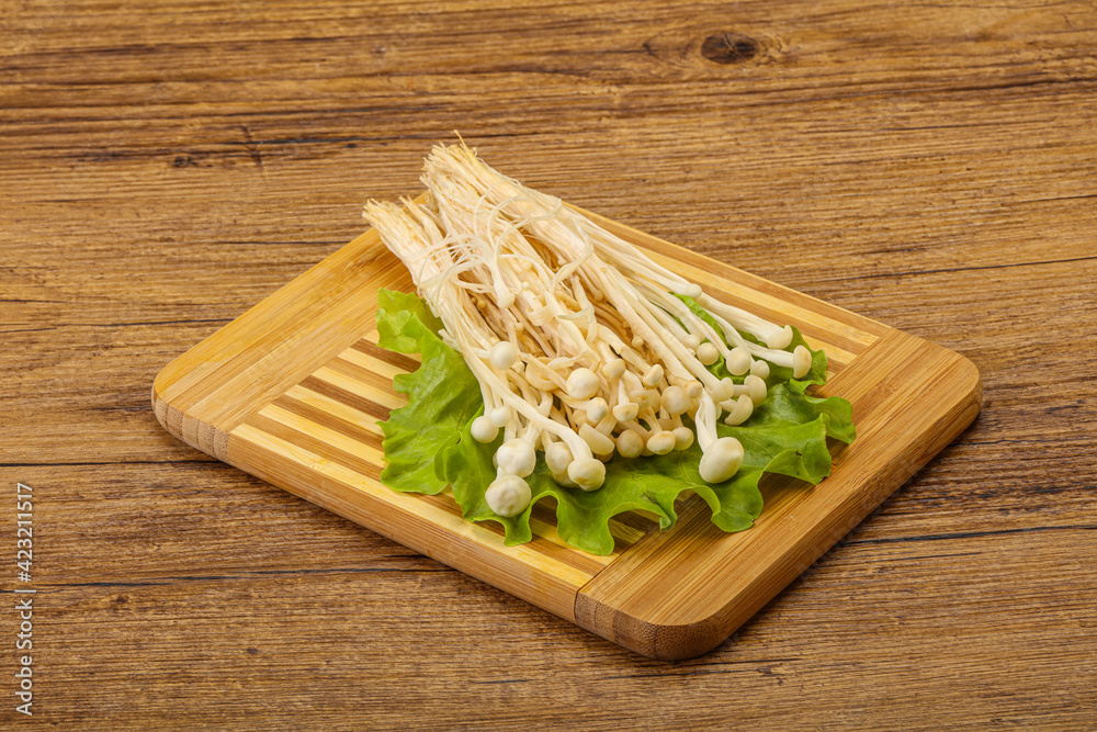 Raw Enoki mushrooms for cooking Raw Enoki mushrooms for cooking