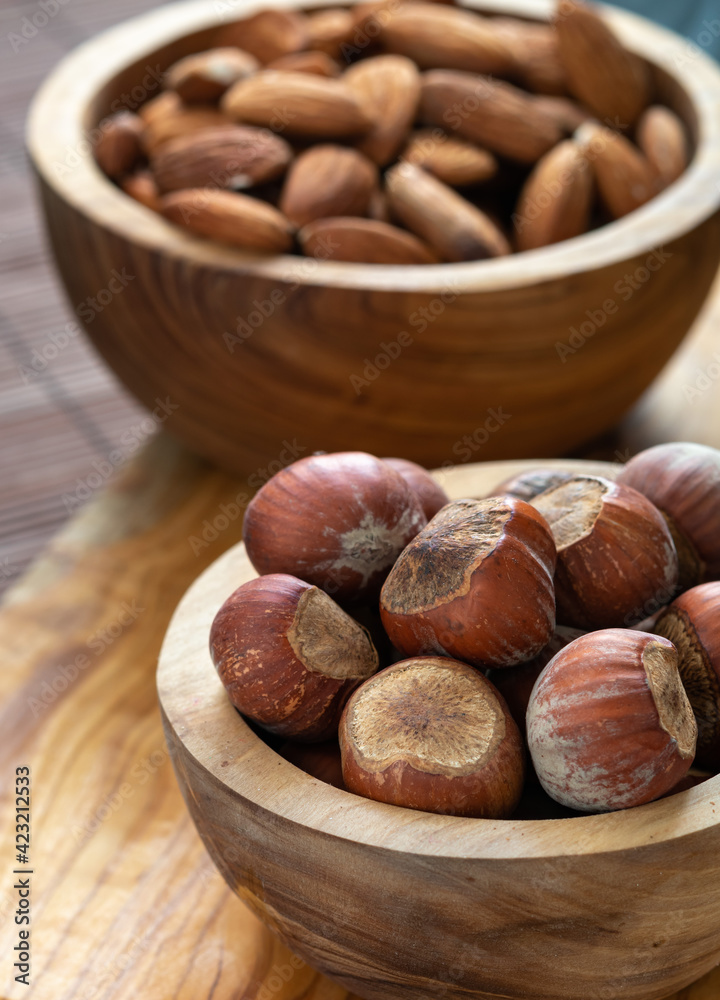 snack food concept, nuts in wooden plates on the table snack food concept, nuts in wooden plates on the table