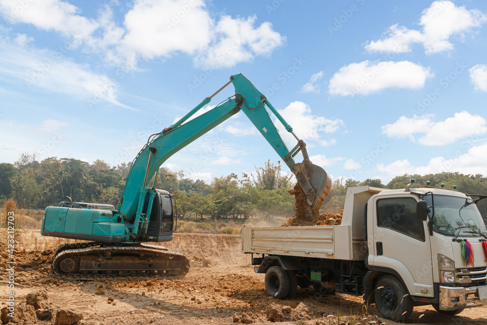 Crawler Excavator digging the soil into a truck ,In the construction site area outdoor . Crawler Excavator digging the soil into a truck ,In the construction site area outdoor .