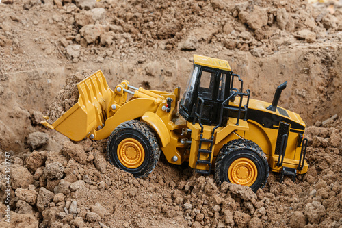 Wheel loader are digging the soil in the construction site ,side view