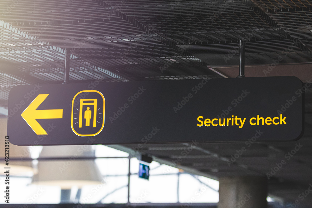 Airport informaction signs. Arrow on information screen leading to security check
