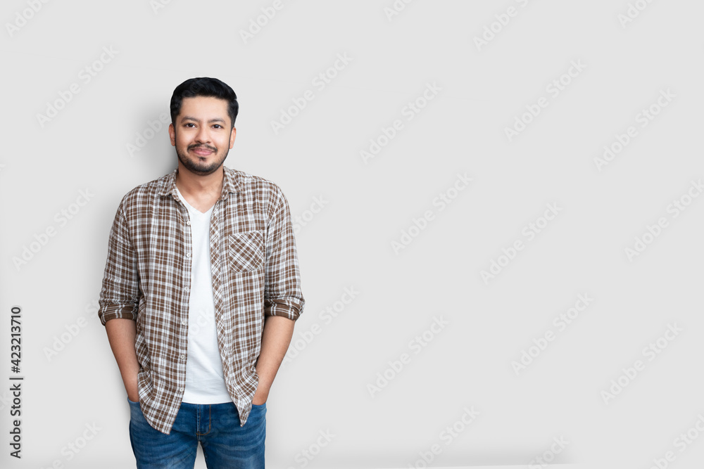 Attractive beautiful positive happy asian man. Handsome asian pakistani guy wearing brown checked shirt with big smile isolated on white background Attractive beautiful positive happy asian man. Handsome asian pakistani guy wearing brown checked shirt with big smile isolated on white background