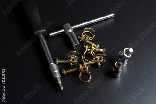 metal wire clamps and tools on black background