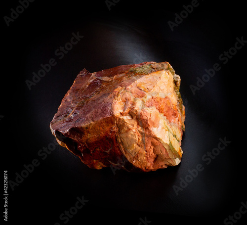 Red beautiful jasper mineral crystal from Orsk, Ural, Russia. A photo of a stone isolated on black. For geology or mineralogy websites, stone collection catalog, Natural Science museum wall charts. photo