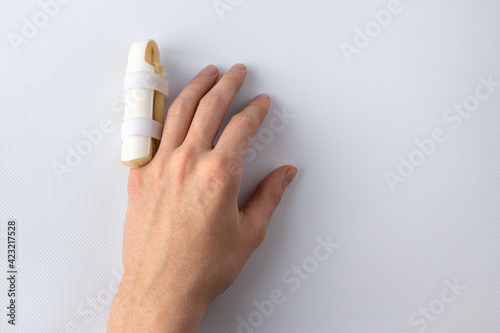 medical splint on a broken finger, on a white background. Medical assistance in case of injury