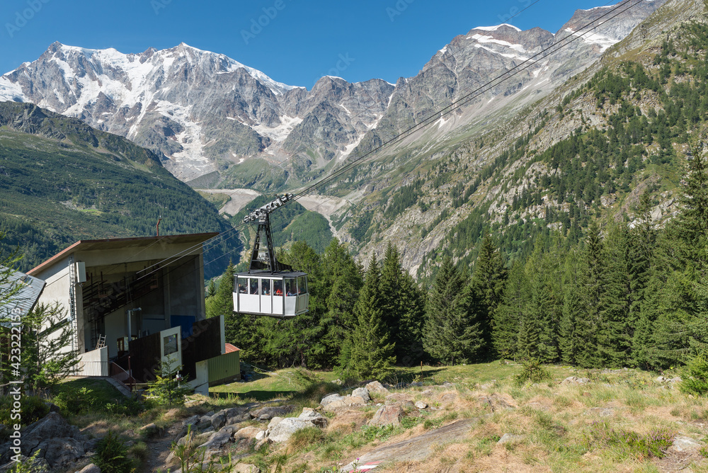 Cable car in the high mountains. Tourism and hiking concept. Macugnaga, Italy with the Bill - Monte Moro cable car in the European Alps. In the background the Monte Rosa. Focus on the cable car cabin
