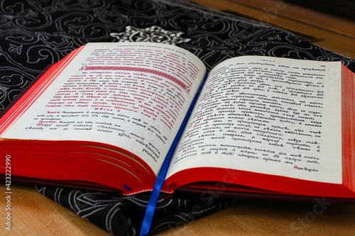 An open religious Orthodox book in the old church language lies in the church during the Orthodox liturgy. The concept of Orthodoxy.