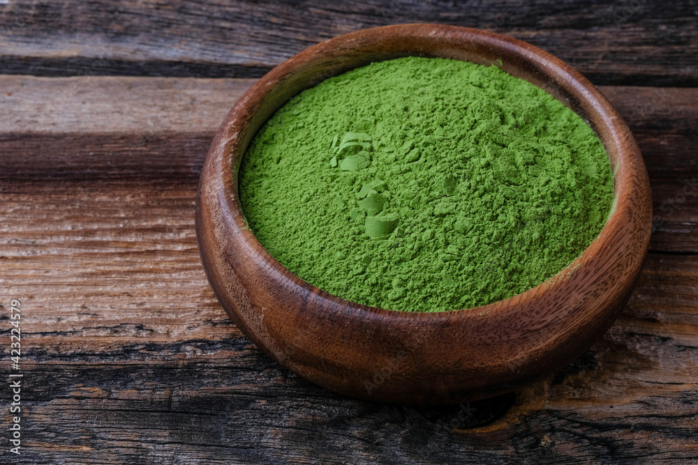 Green vegetables powder on wooden cup and wooden background, copyspace Green vegetables powder on wooden cup and wooden background, copyspace