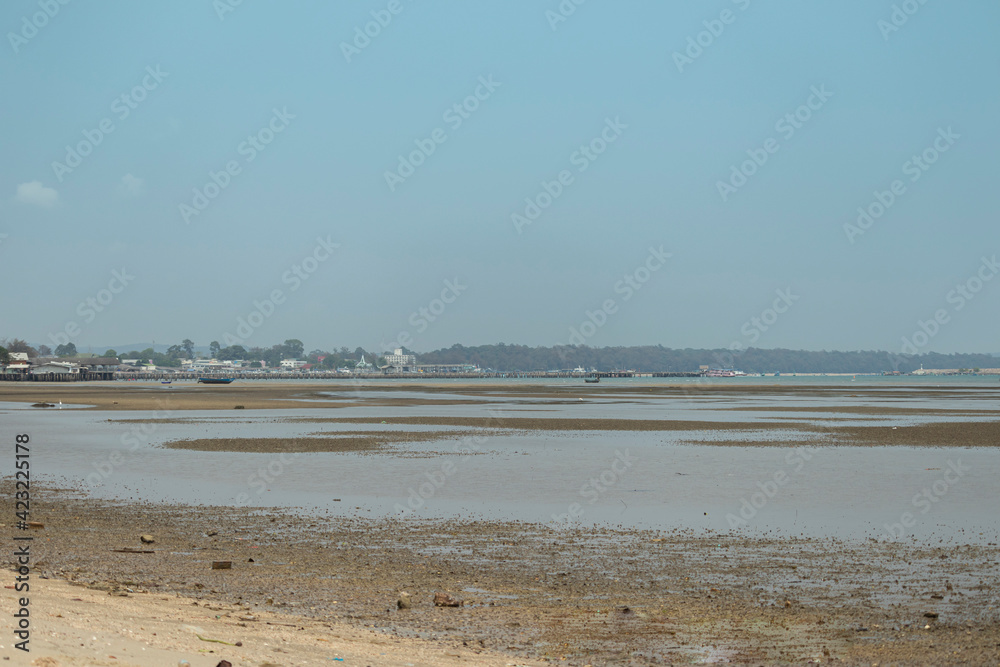 Sand floor on the beach after the sea has dropped. Become a wide beach with a background of a passenger ship