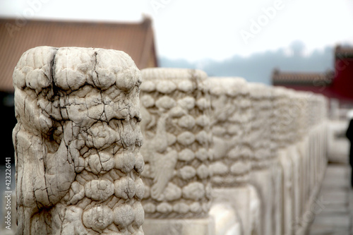 Background. a line of ancienct stone, marble pillars with traditional oriental architecture.