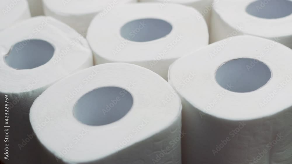 Rolls Of White Soft Toilet Paper, Macro, Background, Insulated, Rotate. The Concept Of Care, Cleanliness, Hygiene. Background of Rolls of Multi-Layer Toilet Paper.