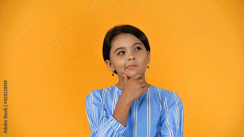 pensive preteen child looking away isolated on yellow pensive preteen child looking away isolated on yellow