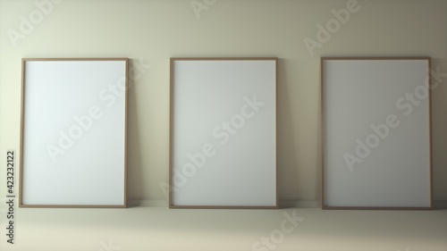 Blank three vertical posters mock up standing on beige floor. Three wooden frames isolated in Scandinavian interior. 3d rendering