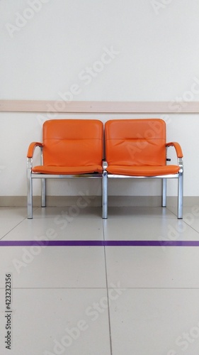 metal chairs with bright orange leather seats