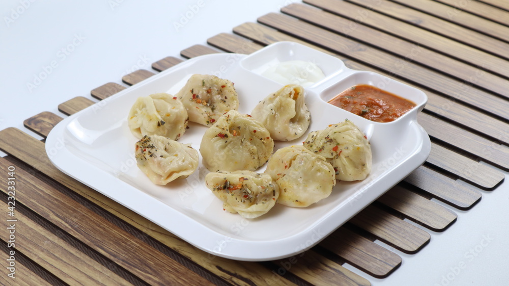 Veg steam momos. Momos stuffed with vegetables and then cooked and served with sauce Veg steam momos. Momos stuffed with vegetables and then cooked and served with sauce