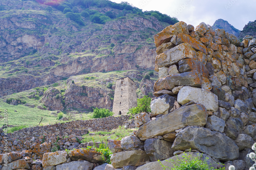 The burial tower of Abai-Kala on the background of an ancient abandoned village. Chegetskoe gorge
