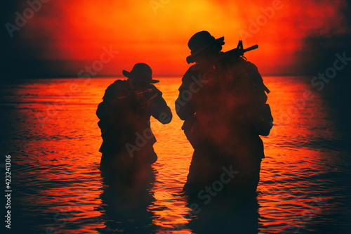 Billede på lærred Commando soldiers walking in water, army special operations forces fighters snea