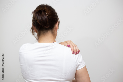 Woman suffering from shoulder pain.